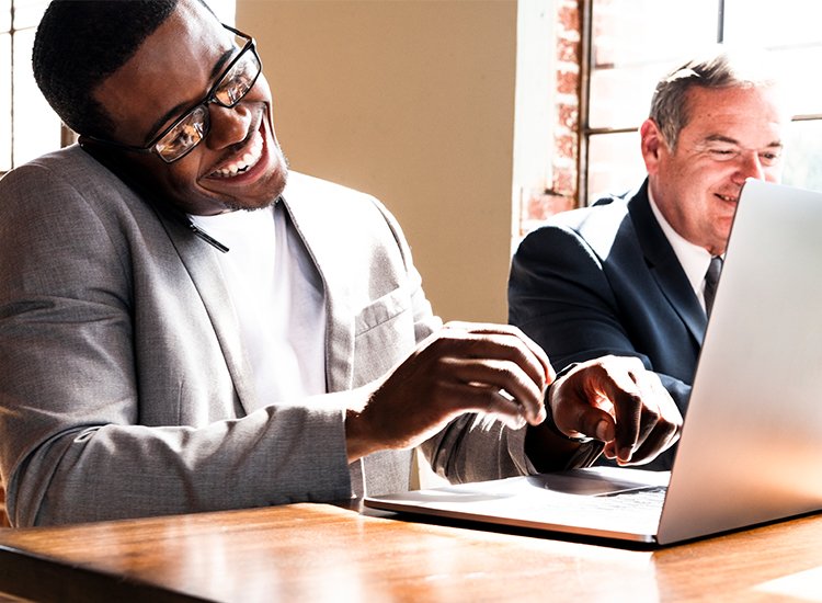 Two professionals reviewing a laptop together